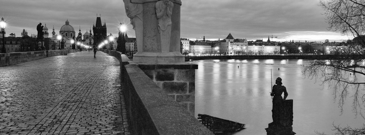 Friday Favourites #lycricallyspeaking. Black and white panoramic shot at night time on a bridge with a view of water.