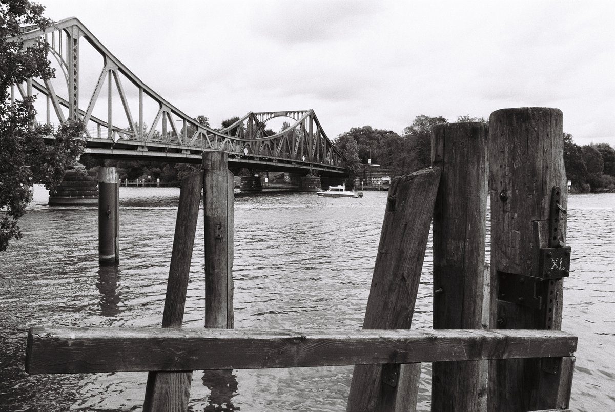 Friday Favourites #lycricallyspeaking. Black and white image of water with a bridge.