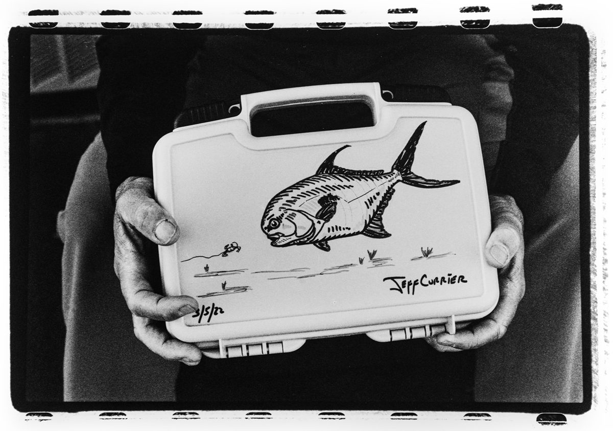 Arian Stevens. Black and white darkroom print of a box with a fish on it.