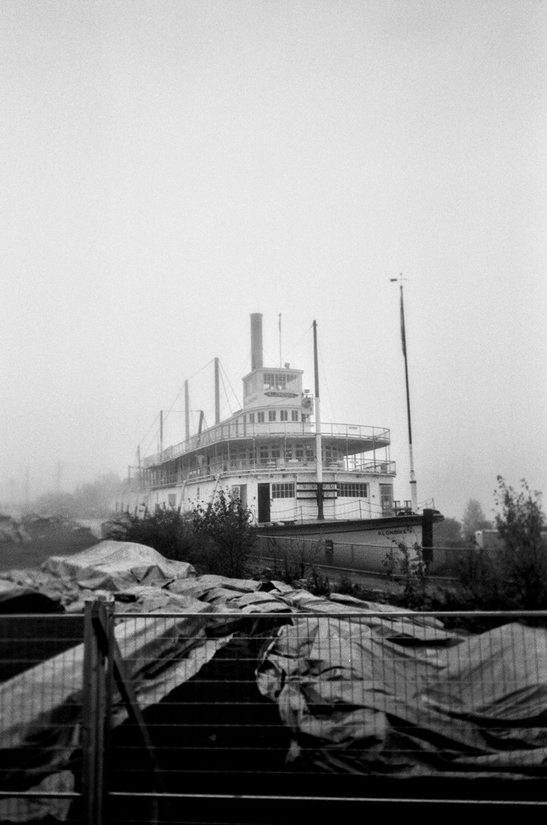 Friday Favourites #spookyfilm. Black and white shot of a boat on land surrounded by fog.