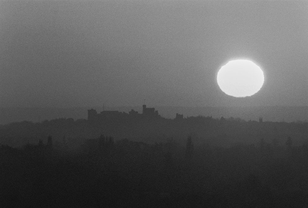 Friday Favourites. Black and white image of the sun going down surrounded by landscape.