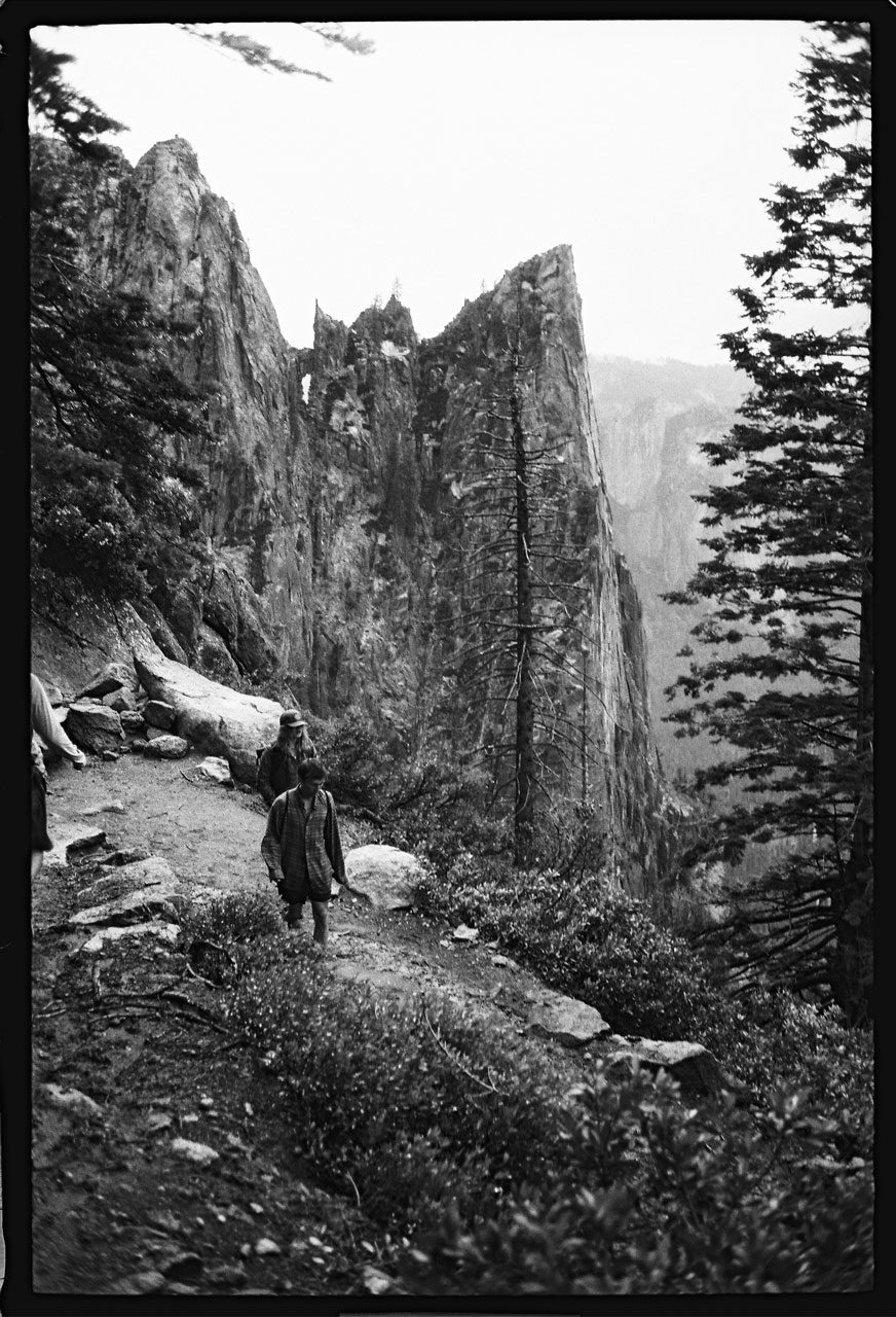 Justin Olsen. Black and white image of a person hiking in the mountains.