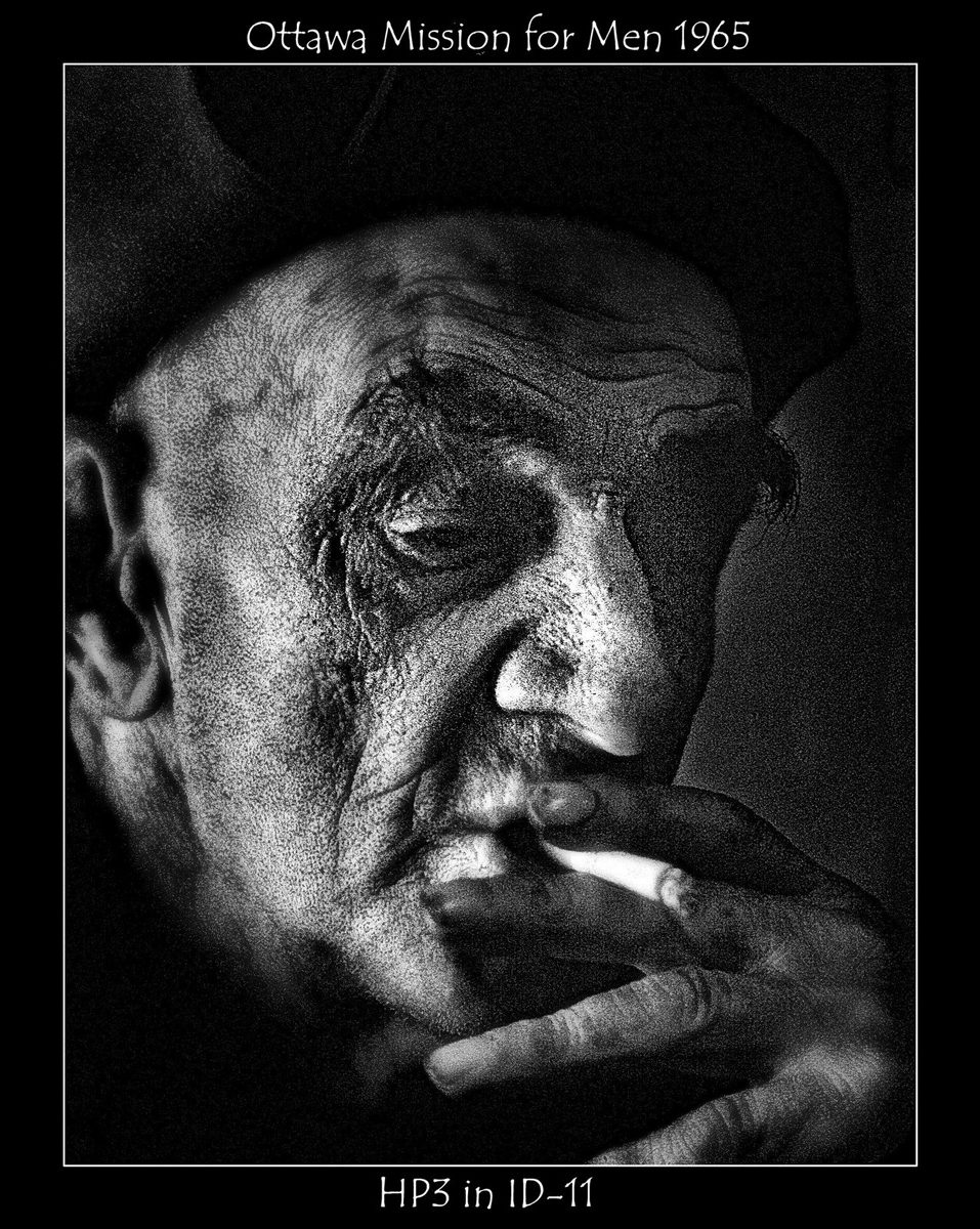 Crombie McNeill. Black and white shot of a man smoking a cigarette.