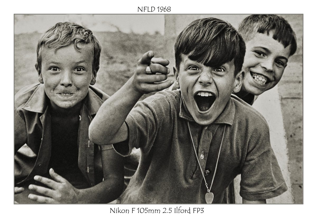 Crombie McNeill. Sepia shot of three boys pointing and laughing.