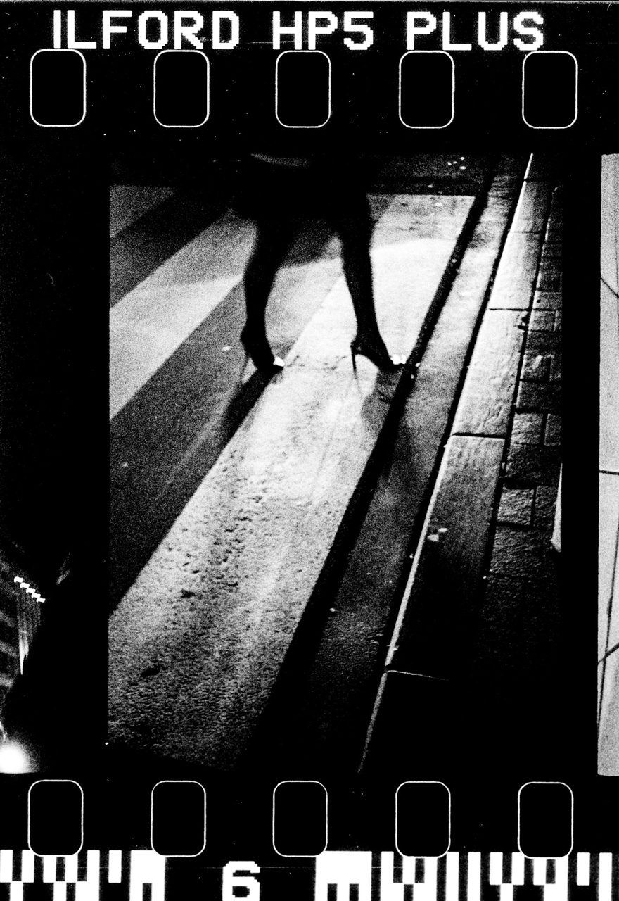 Álvaro Alberto. High contrast black and white feet corssin the road.