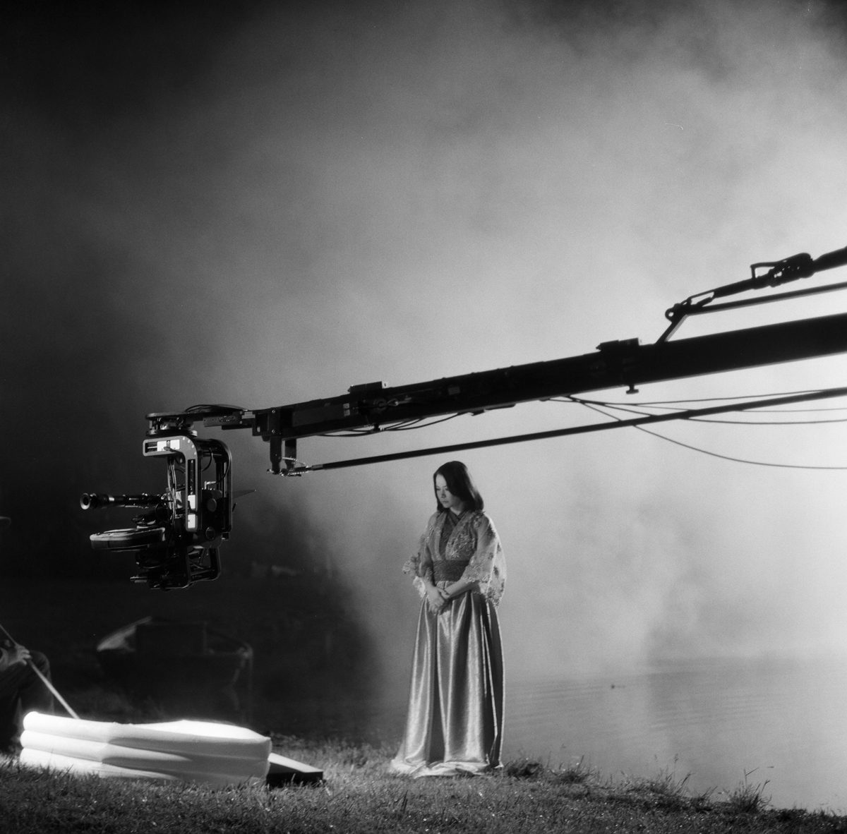 Hannah Baker. Black and white shot of a woman singing with white smoke behind her.