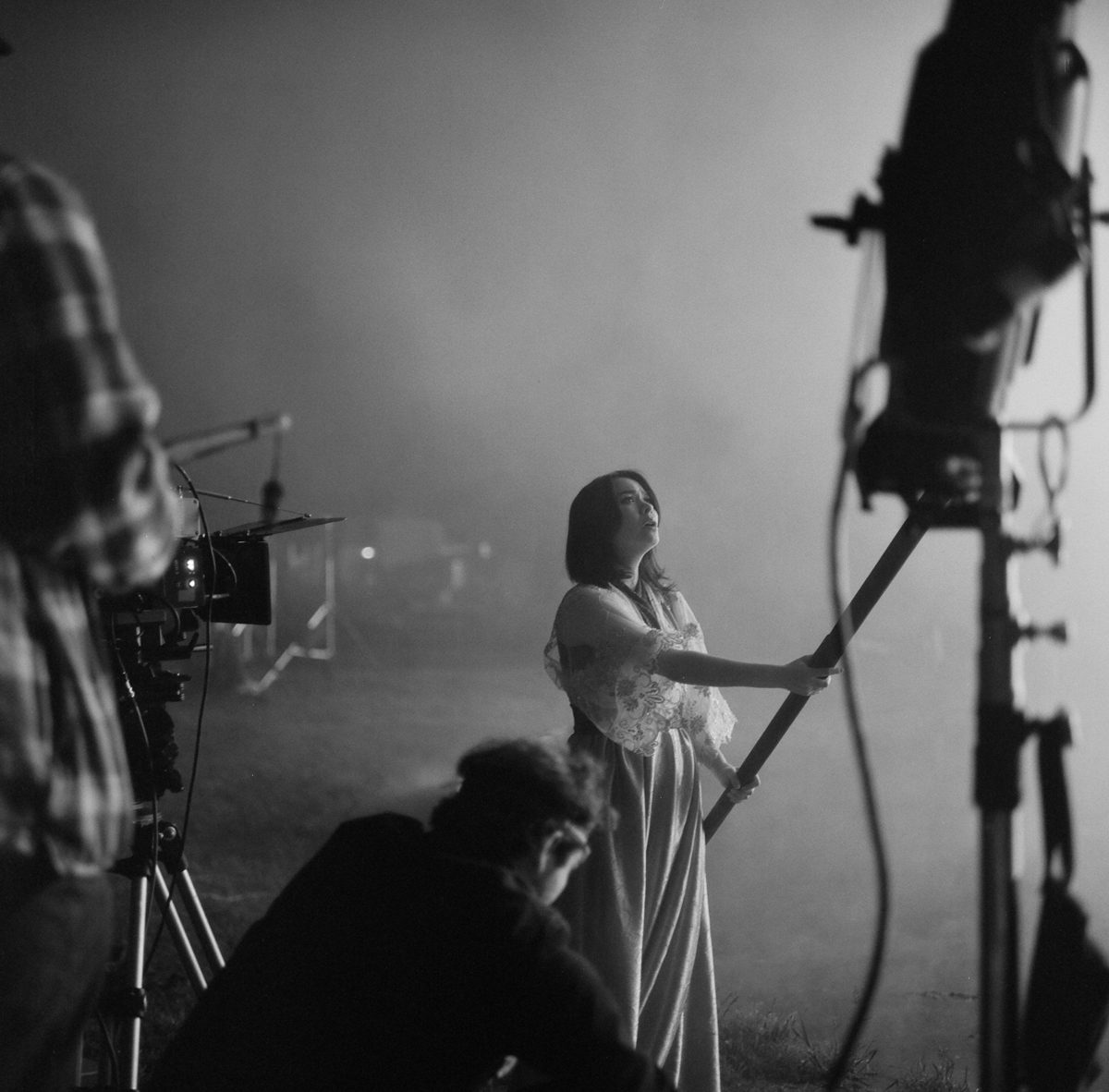 Hannah Baker. Black and white shot of a woman singing with white smoke behind her.