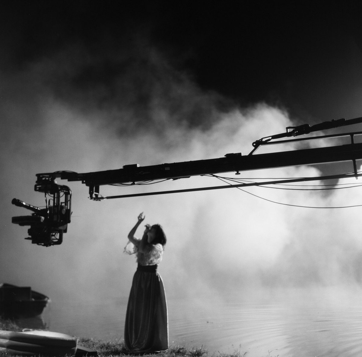 Hannah Baker. Black and white shot of a woman singing with white smoke behind her.