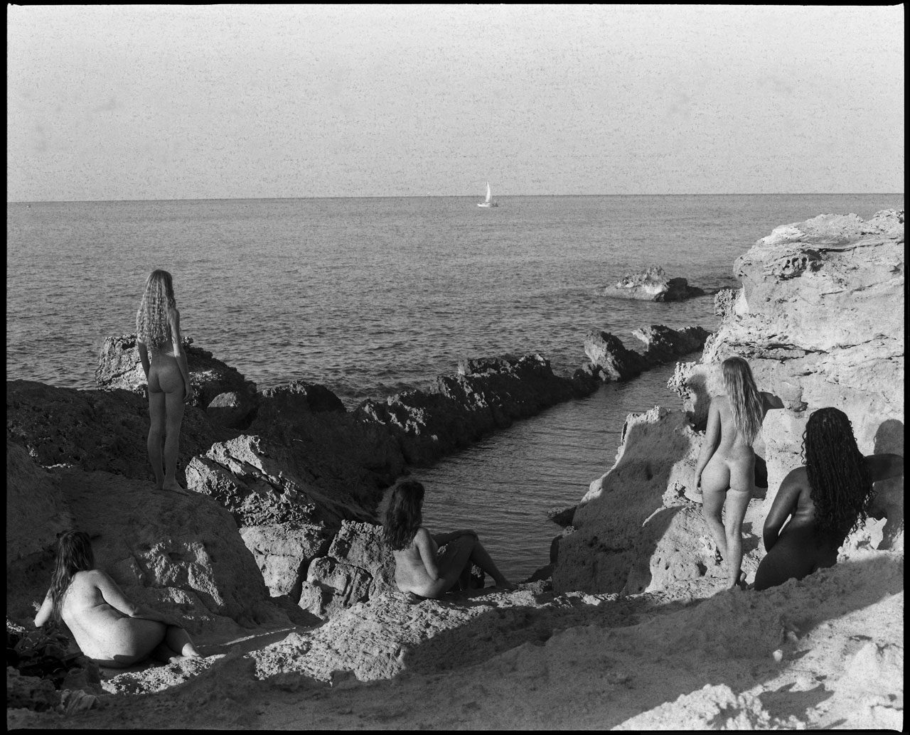 Clarissa Sofia. Black and white image of multiple woman naked stood looking at the view.