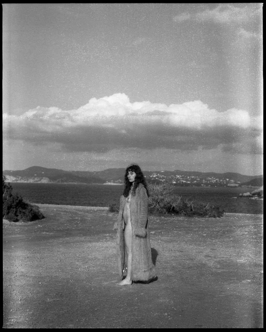 Clarissa Sofia. Black and white portrait of a woman on the beach.