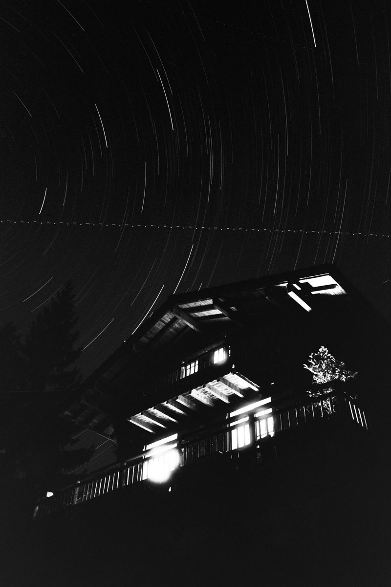 Friday Favourites #themefree. Black and white image of a long exposure star shot with a house.