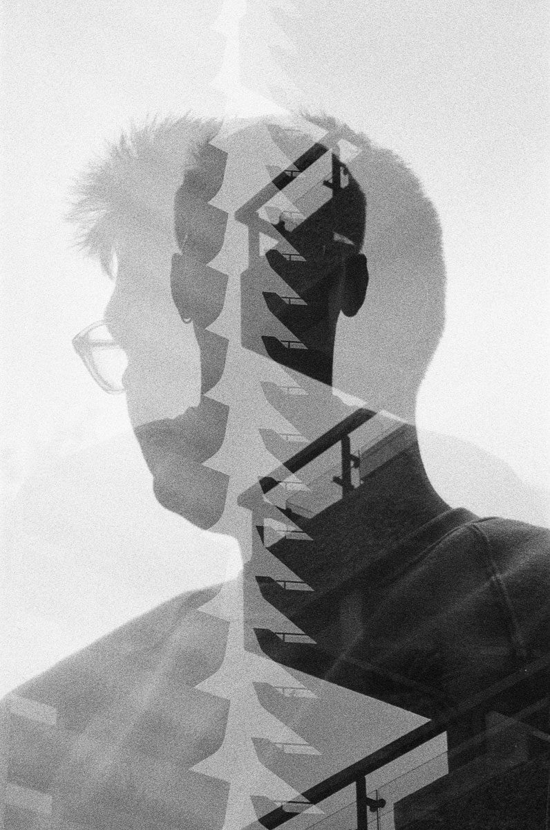 Euan Grimley. Black and white double exposure portrait with stairs in the middle.