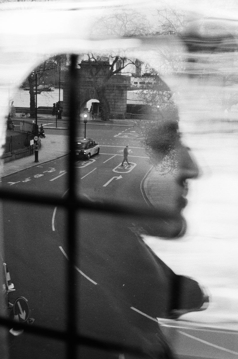 Euan Grimley. Black and white double exposure portrait with a road going through the middle.