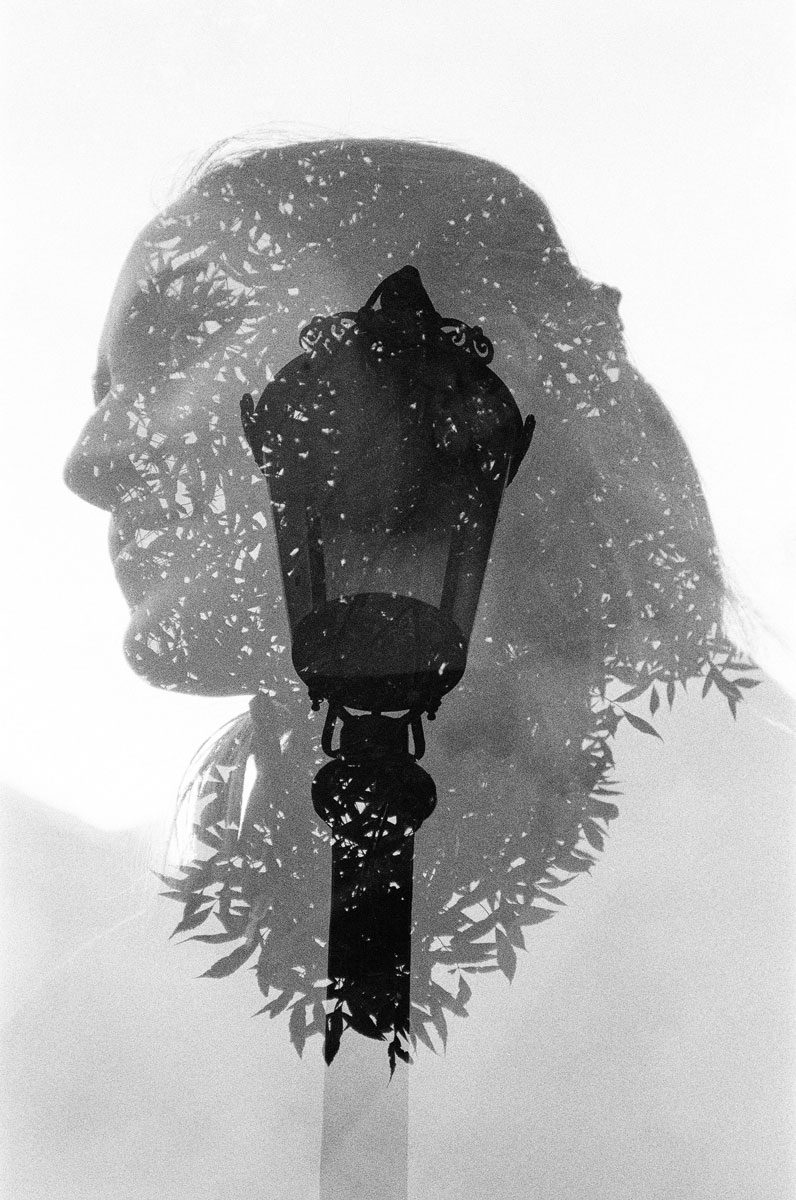 Euan Grimley. Black and white double exposure of a woman with a lamp post in the middle