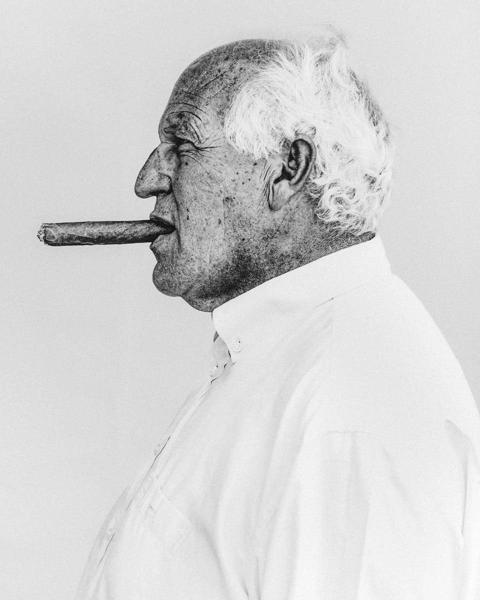 In Focus Jakob Stolz. Black and white portrait of an old man smoking a cigar in his mouth.