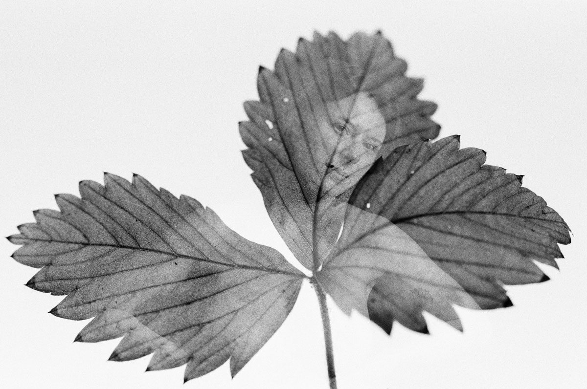 Ben Felton. Black and white double exposure of a leaf and a portrait of a woman.