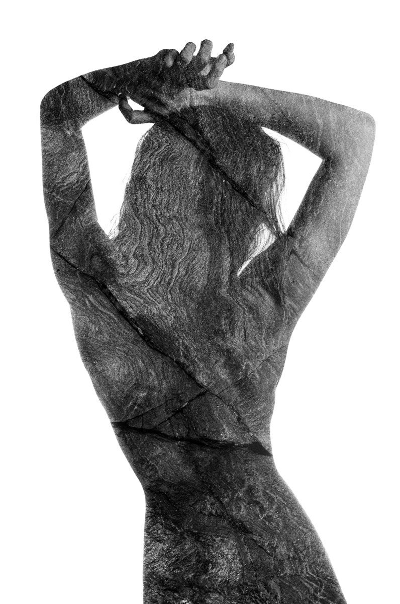 Ben Felton. Black and white double exposure of a naked lady's back with her hands up in the air.