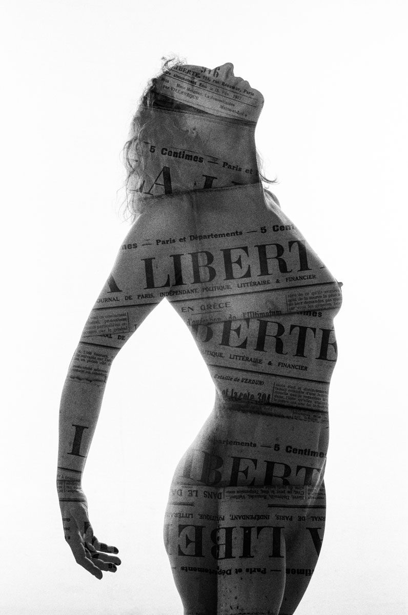 Ben Felton. Black and white double exposure of a woman's body exposed with newspaper