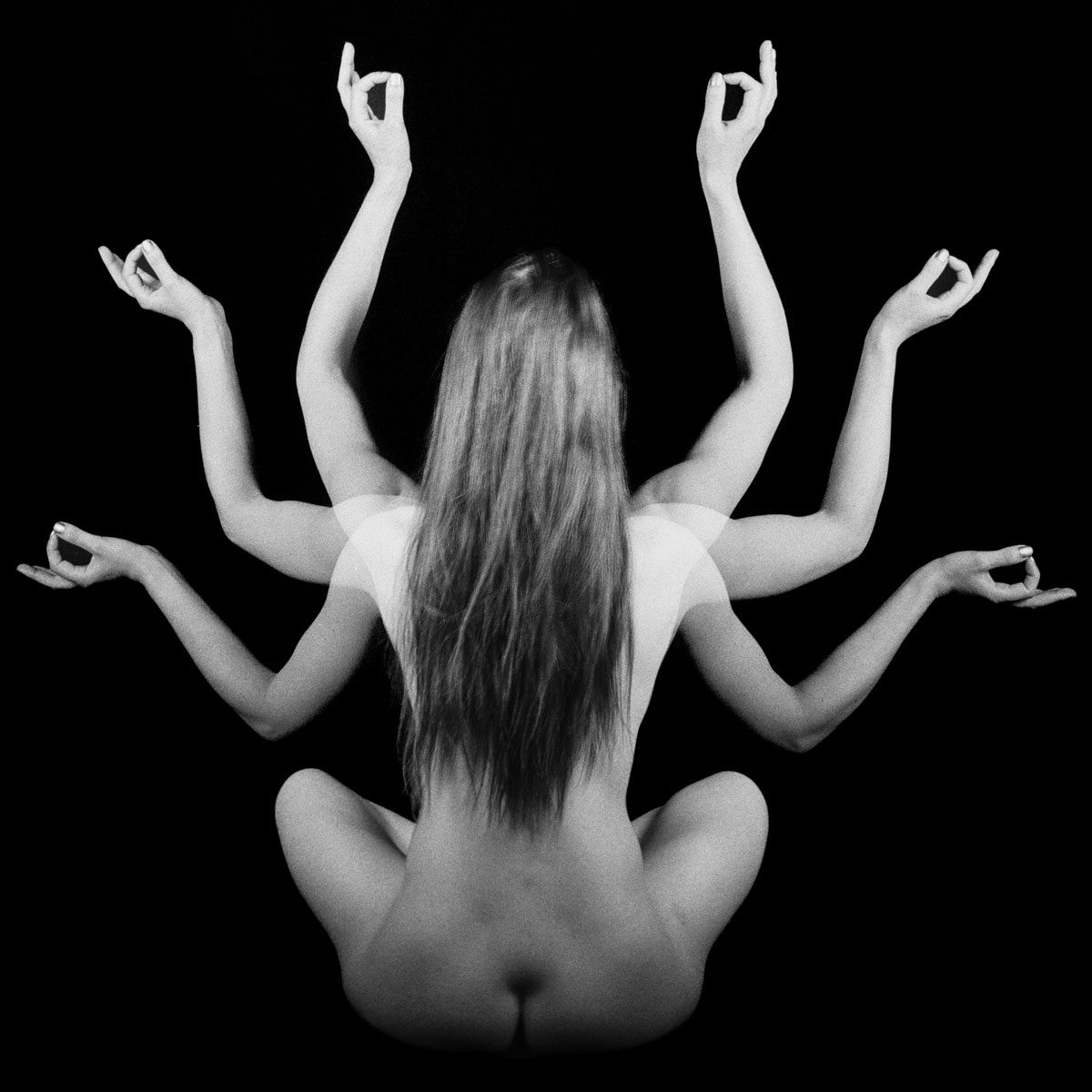 Ben Felton. Black and white double exposure of a woman sat down with 6 arms.