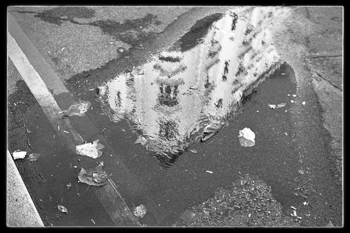 Friday Favourites #themefree. Black and white image of a reflection of a building through a puddle.