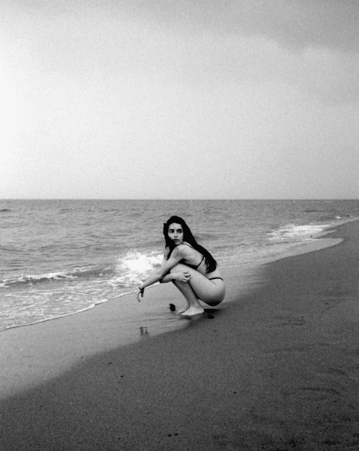 Friday Favourites. Black and white portrait of a woman on the beach in a bikini.