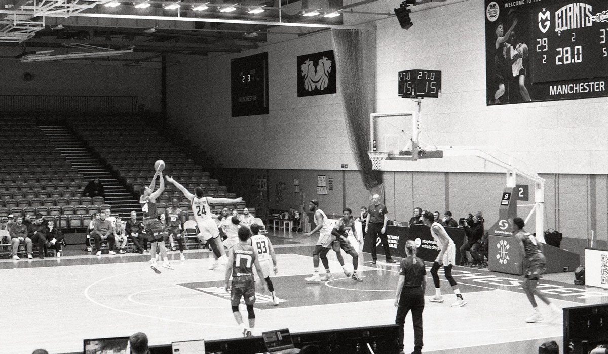 Behind The Film - Kieran Collings. Black and white action shot of a baseball game.