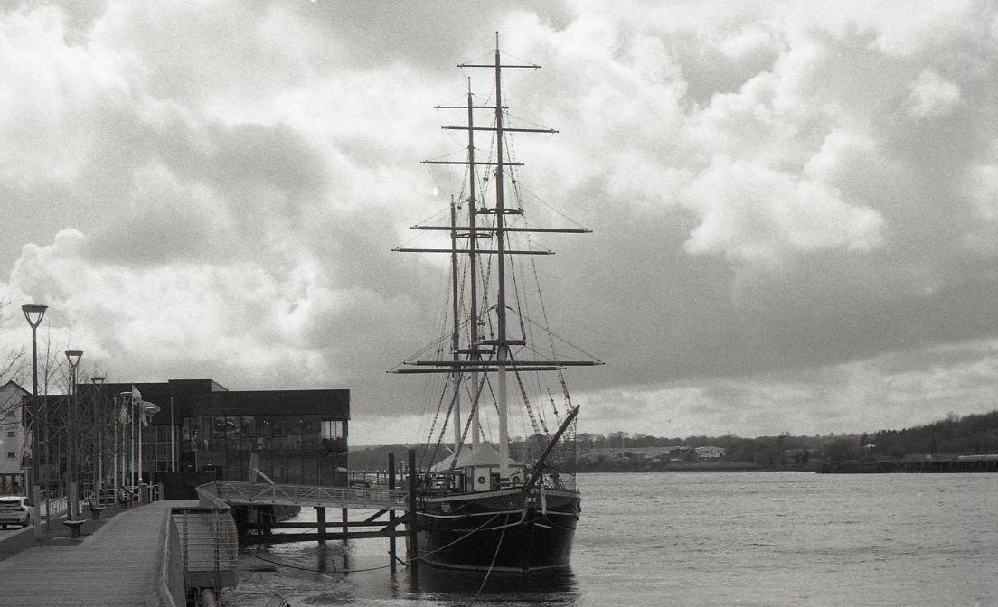 Behind The Film - Kieran Collings. Black and white shot of boat on water.