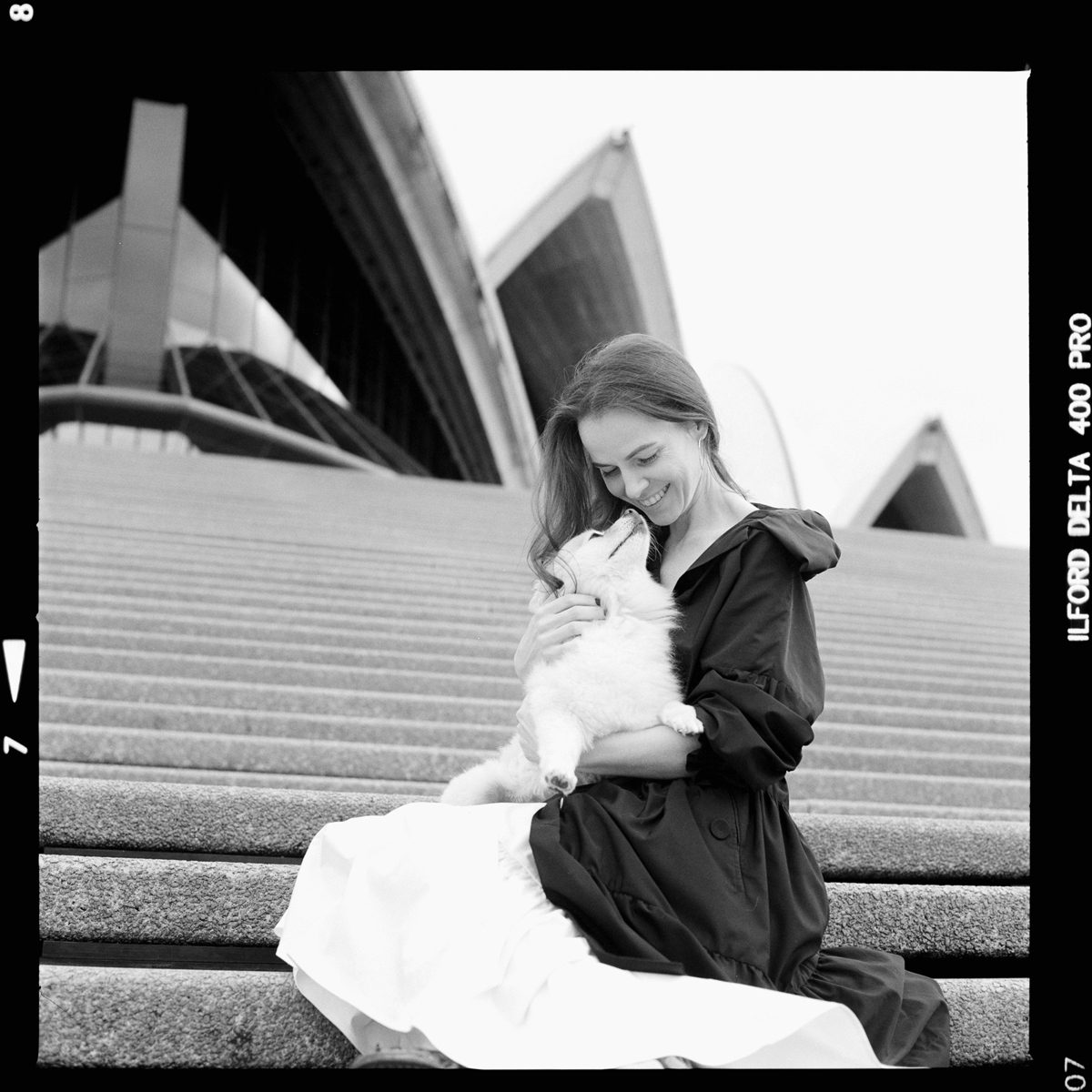 Friday Favourites #febondp400. Black and white portrait of woman sat on steps hugging a white dog.