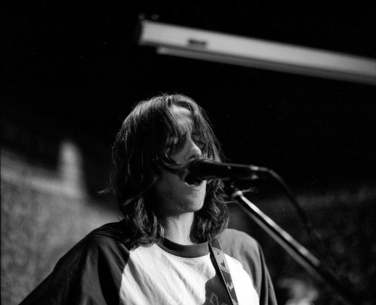 Friday Favourites #febonkentmere400. Black and white picture of a man singing on stage.