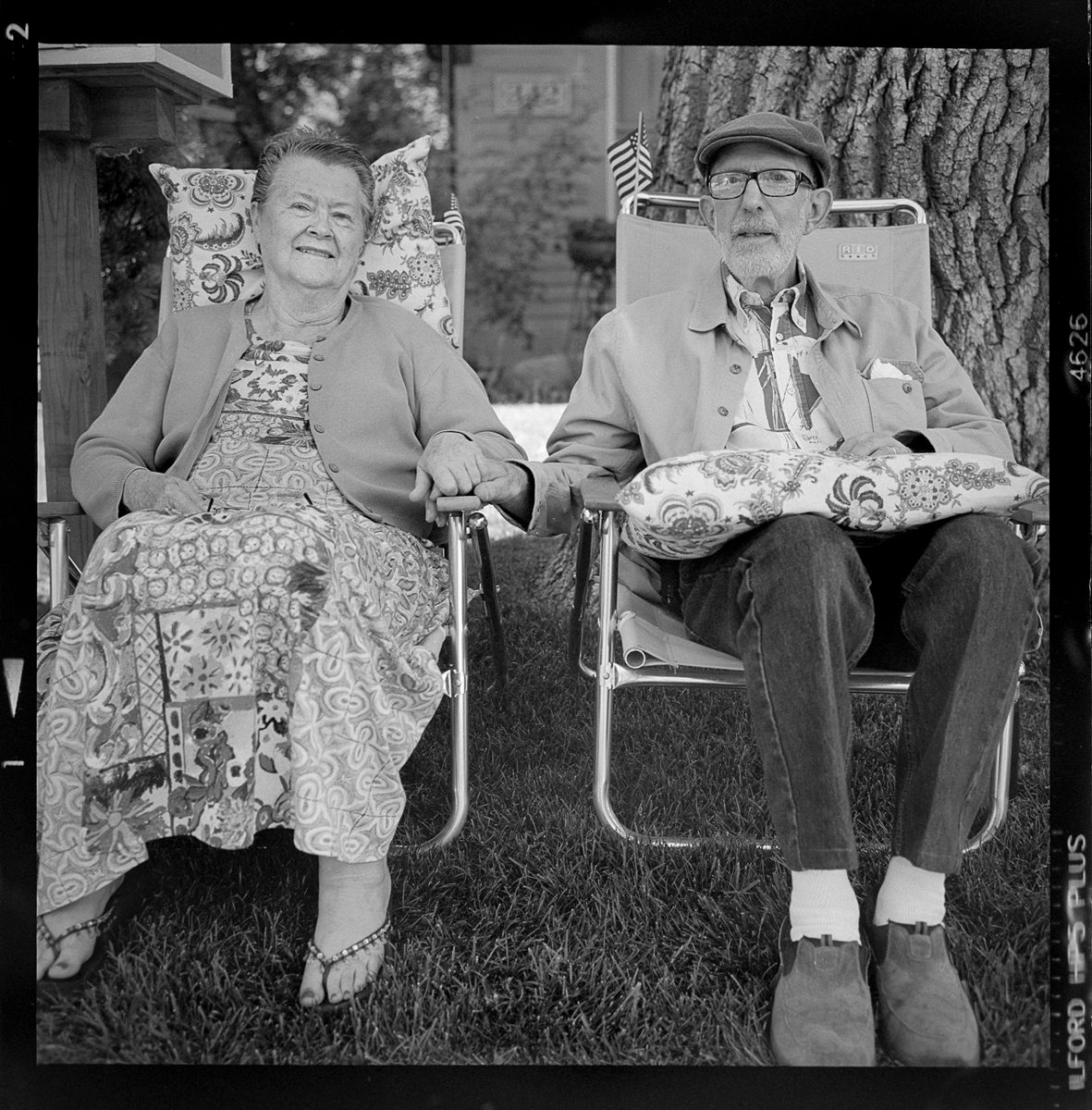 Kenneth Wadja. Black and white image of an elderly couple relaxing in deck chairs.