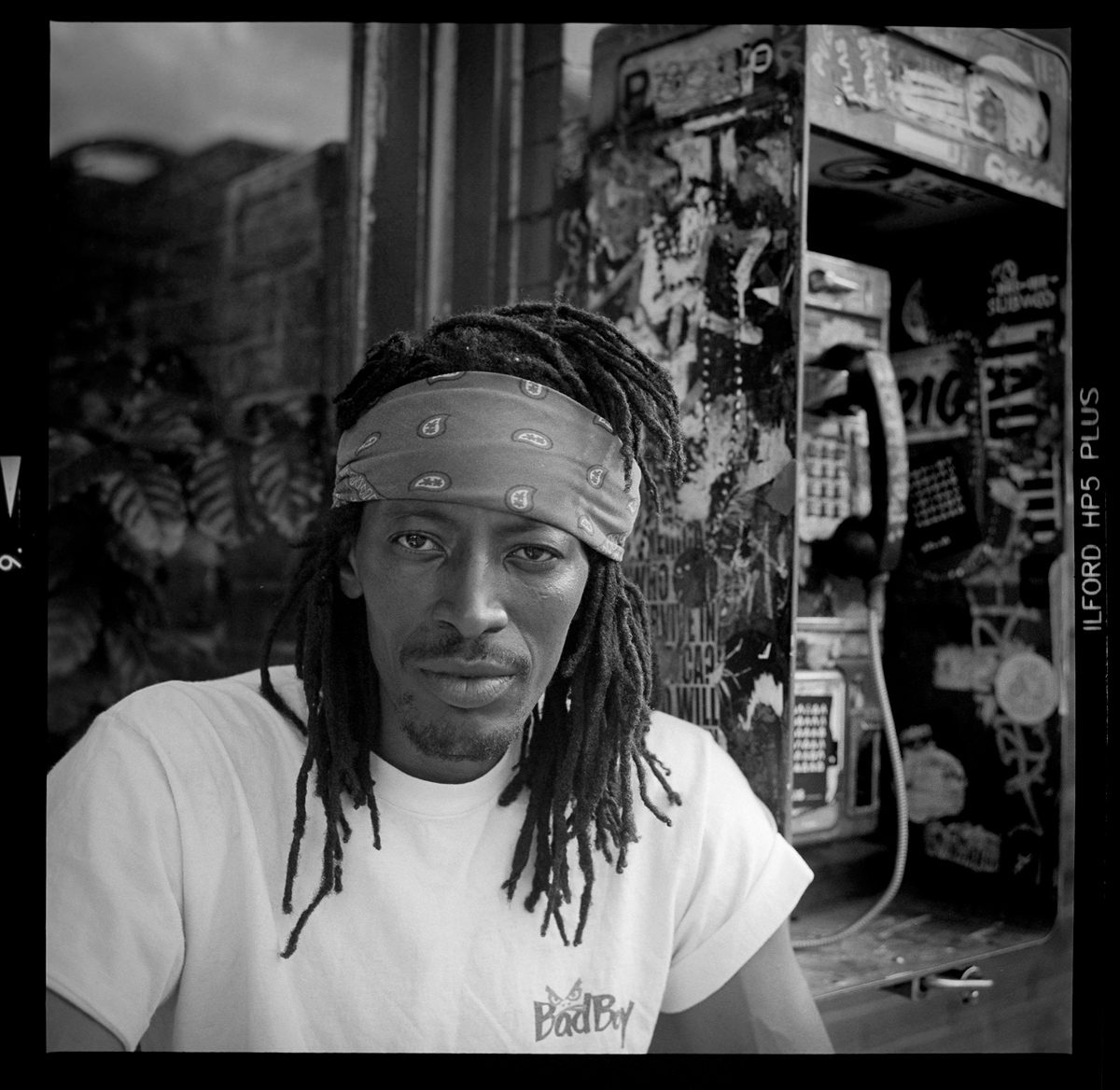 Kenneth Wadja. Black and white portrait of a man with dreadlocks.