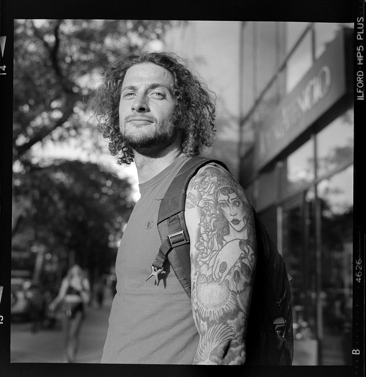 Kenneth Wadja. Black and white portrait of a man with tattoos.