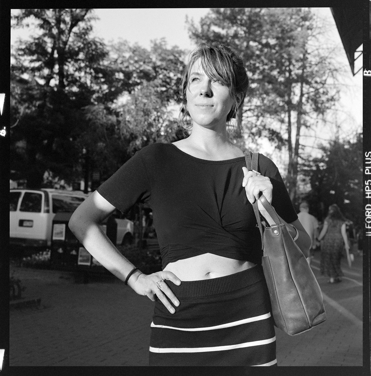 Kenneth Wadja. Black and white portrait of a woman posing in the street.