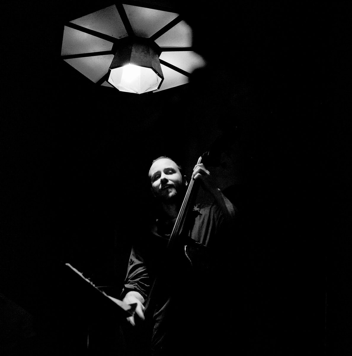 Black and white shot of a man playing an instrument